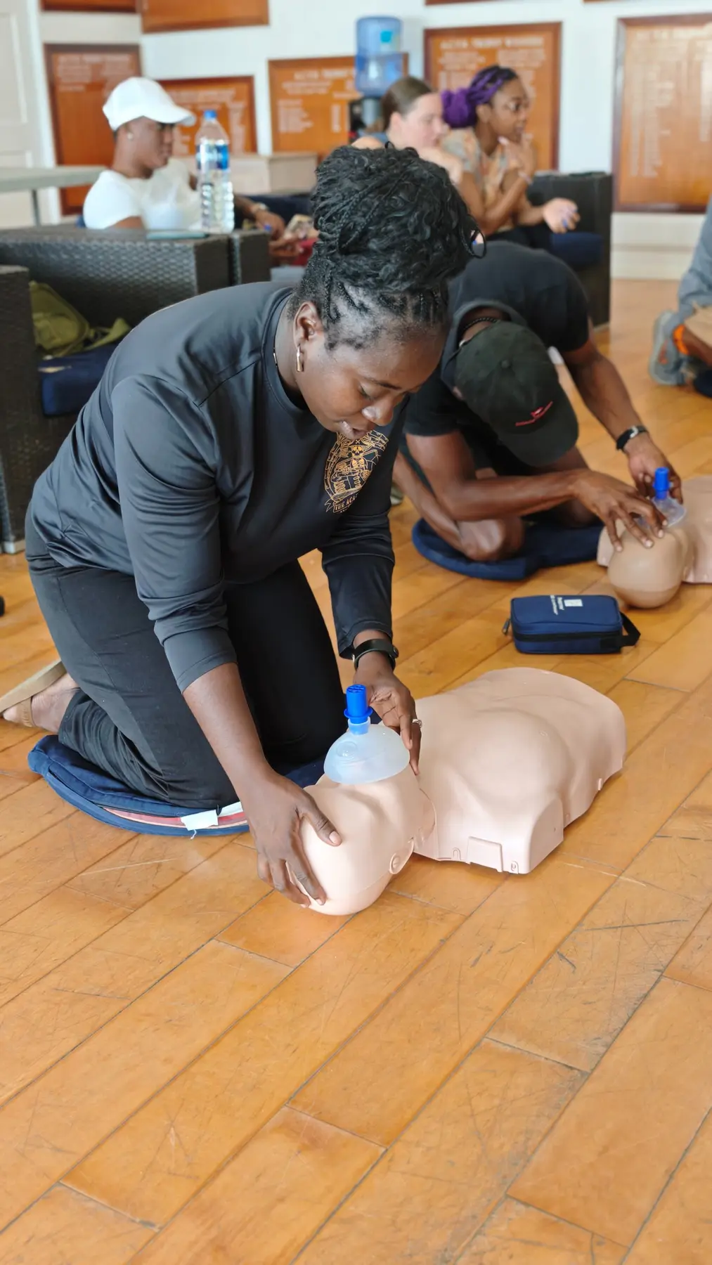 Academy instructor practising rescue breathing during CPR training